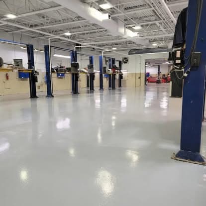 Auto dealership service bay with full-broadcast flake epoxy and gloss topcoat — Long Island NY