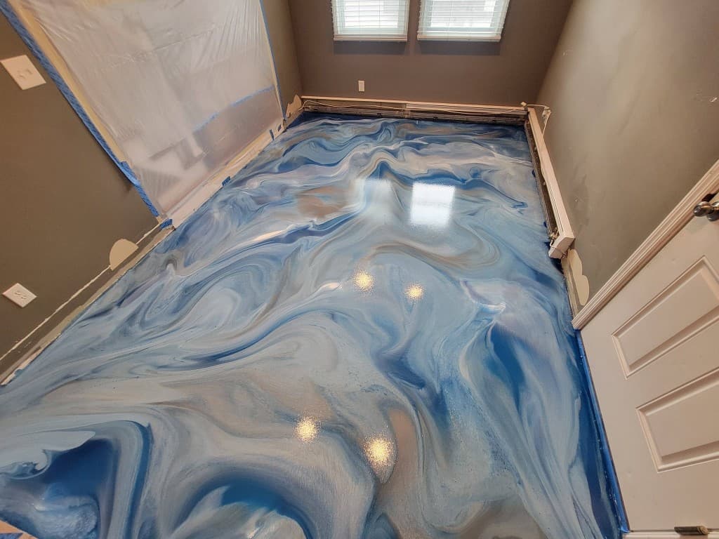 Metallic epoxy floor — ocean-blue swirl with silver highlights, bedroom installation Long Island